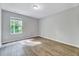 Bedroom featuring a hardwood floors, neutral paint, and natural light from the window at 217 Carolina Town Ln, Holly Springs, NC 27540