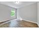 Serene bedroom with a large window, hardwood floors, and neutral walls, creating a peaceful retreat at 217 Carolina Town Ln, Holly Springs, NC 27540