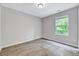 Comfortable bedroom with natural light from the window offering a relaxing and inviting ambiance at 217 Carolina Town Ln, Holly Springs, NC 27540