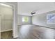 Spacious primary bedroom featuring hardwood floors, natural light, and a ceiling fan at 217 Carolina Town Ln, Holly Springs, NC 27540