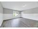 Bright bonus room featuring hardwood floors, white wainscoting, and plenty of space at 217 Carolina Town Ln, Holly Springs, NC 27540