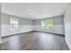 Spacious bonus room with hardwood floors, neutral paint, and natural light from the multiple windows at 217 Carolina Town Ln, Holly Springs, NC 27540