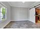 The dining room has modern lighting, wood floors, and access to the kitchen at 217 Carolina Town Ln, Holly Springs, NC 27540