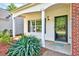 Covered porch leads to the front door, highlighted by neat landscaping at 217 Carolina Town Ln, Holly Springs, NC 27540