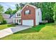 View of a two-story home with a lush lawn, showcasing its suburban setting at 217 Carolina Town Ln, Holly Springs, NC 27540