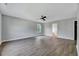 Bright living room featuring hardwood floors, ceiling fan, and neutral paint, offering a modern and inviting space at 217 Carolina Town Ln, Holly Springs, NC 27540