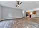 Open concept living area showcasing hardwood floors, a ceiling fan, and neutral walls at 217 Carolina Town Ln, Holly Springs, NC 27540