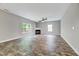 Sun-filled living room with a cozy fireplace and large windows offering ample natural light at 217 Carolina Town Ln, Holly Springs, NC 27540