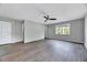 Main bedroom featuring hardwood floors, natural light, a ceiling fan, and ensuite bathroom at 217 Carolina Town Ln, Holly Springs, NC 27540