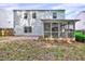 Home showcasing a spacious backyard with a screened porch providing a comfortable outdoor retreat at 217 Carolina Town Ln, Holly Springs, NC 27540