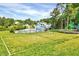 Community recreation area showcasing swimming pool, playground, and volleyball court amid lush greenery at 217 Carolina Town Ln, Holly Springs, NC 27540