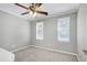 Bright bedroom featuring plush carpet, neutral paint, and modern ceiling fan at 2205 Long And Winding Rd, Raleigh, NC 27603
