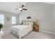 Neutral bedroom with a ceiling fan, two windows, and carpeted flooring at 2205 Long And Winding Rd, Raleigh, NC 27603