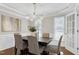 Dining room has hardwood floors, modern lighting fixture, and french doors at 2205 Long And Winding Rd, Raleigh, NC 27603