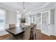 Dining room showcasing modern light fixture, neutral colors, hardwood floors, and french doors at 2205 Long And Winding Rd, Raleigh, NC 27603