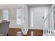 Open entry space with hardwood floors, stairs with white railing, and view into dining room at 2205 Long And Winding Rd, Raleigh, NC 27603