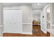 Bright hallway with wood floors leading to other rooms and a closet at 2205 Long And Winding Rd, Raleigh, NC 27603