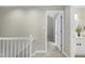 Upstairs hallway with white railings and an open view to the ensuite bathroom at 2205 Long And Winding Rd, Raleigh, NC 27603