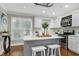 Modern kitchen with an island and seating and stainless steel appliances at 2205 Long And Winding Rd, Raleigh, NC 27603