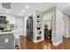 Kitchen with stainless steel refrigerator, hardwood floors, and an island with stools at 2205 Long And Winding Rd, Raleigh, NC 27603