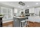 Well-lit kitchen with white cabinetry, an island with seating, and stainless steel appliances at 2205 Long And Winding Rd, Raleigh, NC 27603