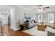 Open concept living room with a couch, hardwood flooring, and neutral colors at 2205 Long And Winding Rd, Raleigh, NC 27603