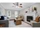 Living room has neutral decor, a fireplace, a ceiling fan, and hardwood floors at 2205 Long And Winding Rd, Raleigh, NC 27603