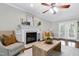 Comfortable living room with fireplace, wood floors, and a light, neutral color scheme at 2205 Long And Winding Rd, Raleigh, NC 27603
