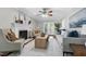Bright living room with a fireplace, ceiling fan, neutral tones, and access to the outdoors at 2205 Long And Winding Rd, Raleigh, NC 27603