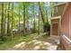 Spacious backyard with mature trees, a shed, and a small wooden bridge feature, offering privacy at 224 Heidinger Dr, Cary, NC 27511