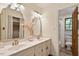 Bathroom featuring double sinks, decorative mirrors and a marble tiled shower with glass door at 224 Heidinger Dr, Cary, NC 27511