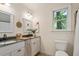 Well-lit bathroom with double vanity, granite countertop, decorative mirrors and a window at 224 Heidinger Dr, Cary, NC 27511