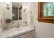 Charming bathroom featuring a stylish vanity, elegant fixtures, and a serene window view at 224 Heidinger Dr, Cary, NC 27511
