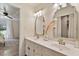 Bathroom featuring double vanity with granite counters, decorative mirrors and a shower at 224 Heidinger Dr, Cary, NC 27511