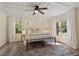 Bright bedroom with white walls, ceiling fan, and large windows offering backyard views at 224 Heidinger Dr, Cary, NC 27511