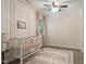 Bedroom with soft pink tones, a crib, and a patterned rug creating a cozy and inviting space at 224 Heidinger Dr, Cary, NC 27511