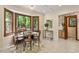 Bright breakfast nook with a bay window overlooking lush greenery and an elegant floral rug at 224 Heidinger Dr, Cary, NC 27511