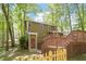 Exterior of a two-story home with a wooden deck, backyard access, and a wooded backdrop at 224 Heidinger Dr, Cary, NC 27511