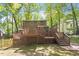 Exterior of a home with a multi-level wooden deck and a backyard surrounded by trees at 224 Heidinger Dr, Cary, NC 27511