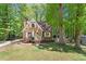 Quaint home with brick facade, surrounded by mature trees and green lawn at 224 Heidinger Dr, Cary, NC 27511
