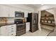 Modern kitchen with stainless steel appliances, ample cabinet space, and a convenient pantry area at 224 Heidinger Dr, Cary, NC 27511