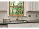 Bright kitchen sink area with a stylish faucet and a serene view of the outdoors at 224 Heidinger Dr, Cary, NC 27511