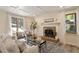 Sun-filled living room with a brick fireplace, and hardwood flooring at 224 Heidinger Dr, Cary, NC 27511