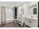 Bright bathroom features double vanity sinks, subway tile shower, and dark laminate floors at 226 Smith Dr, Durham, NC 27712