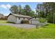 Well-maintained home featuring a gravel driveway, green lawn, and a charming detached garage at 226 Smith Dr, Durham, NC 27712