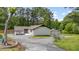 Charming white house with black trim, complemented by a well-maintained yard and ample driveway space at 226 Smith Dr, Durham, NC 27712