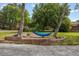 Relaxing blue hammock hung between two trees on a landscaped lawn, perfect for outdoor leisure at 226 Smith Dr, Durham, NC 27712