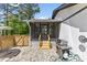 Cozy screened patio with stone flooring, wooden steps, and outdoor grill; perfect for entertaining at 226 Smith Dr, Durham, NC 27712