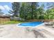 Refreshing outdoor pool with lounge chairs and a picnic table, surrounded by a well-manicured yard at 226 Smith Dr, Durham, NC 27712