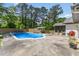 Beautiful pool area with lounge chairs, landscaped yard, and outdoor cooking and dining spaces at 226 Smith Dr, Durham, NC 27712